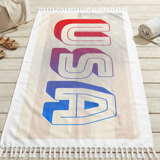 Beach towel with the word "USA" in bold, stylized letters against an American flag background.