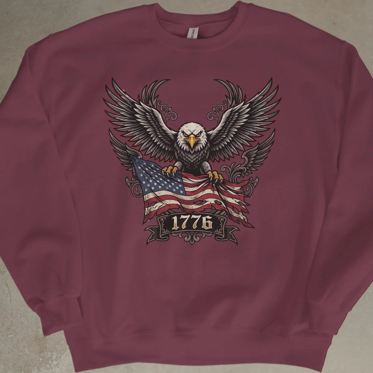 Maroon sweatshirt with eagle, American flag, and "1776" graphic.