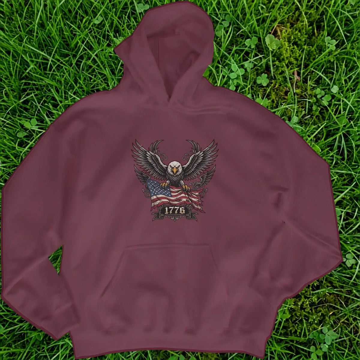 Maroon hoodie with graphic of eagle holding American flag and the year 1776.