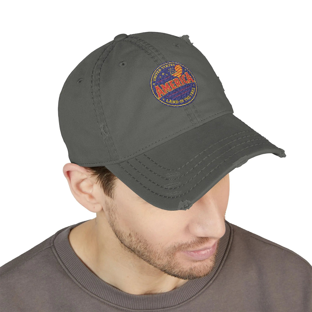 Distressed grey baseball cap with an embroidered circular "America Land of the Free" patch.