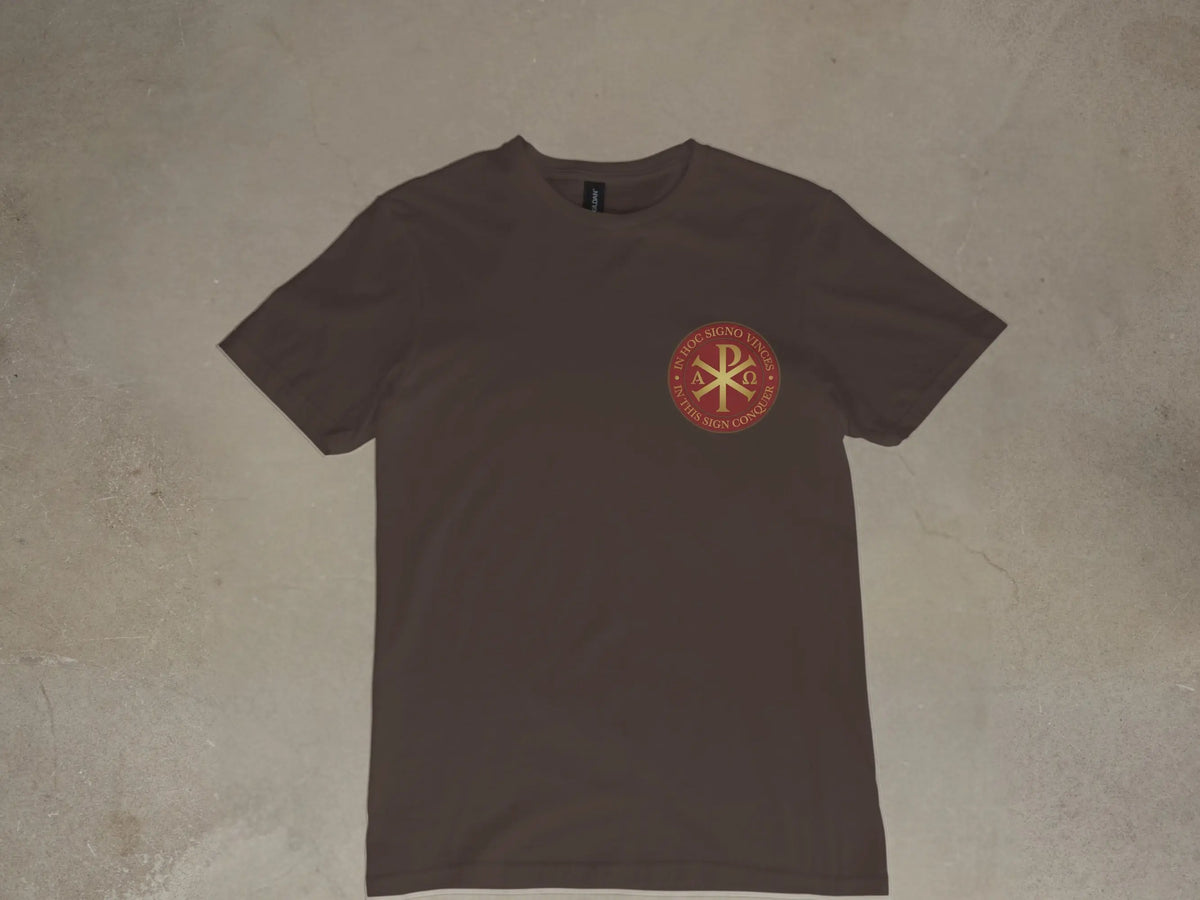 Brown t-shirt with round emblem featuring Chi Rho symbol and Latin/English text.