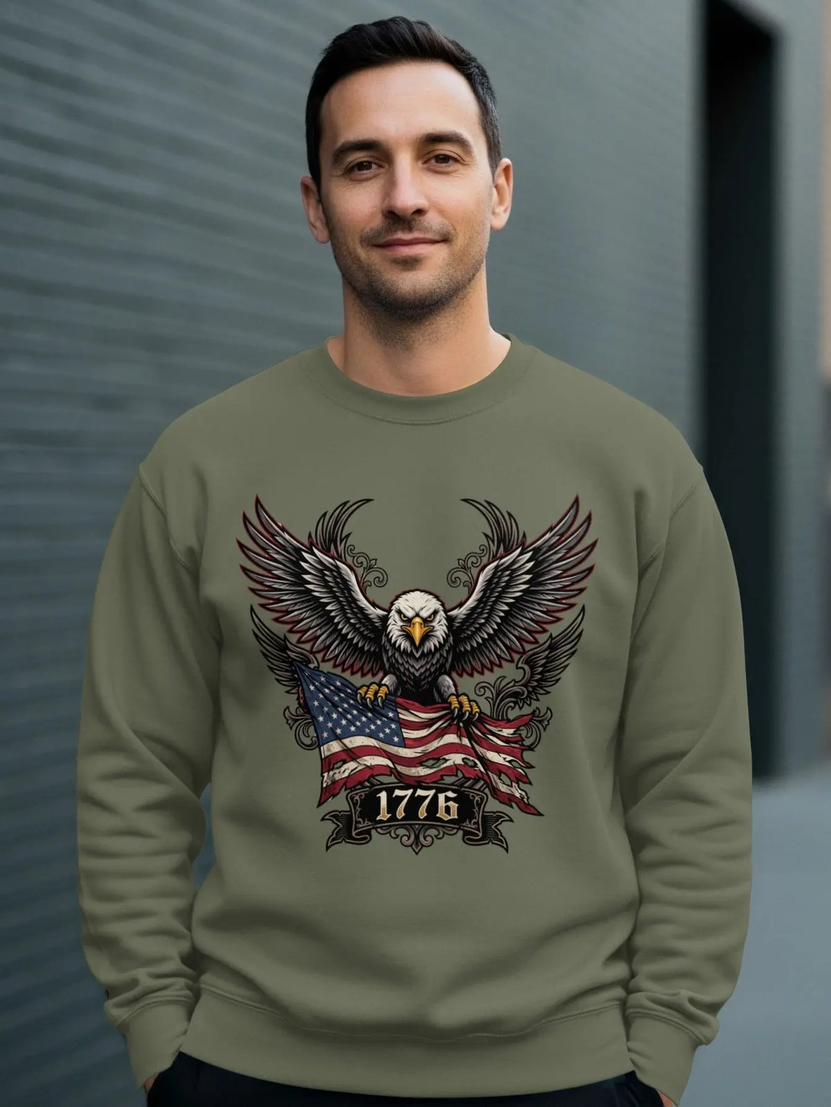 Eagle with outstretched wings holding American flag and "1776" text on olive sweatshirt.
