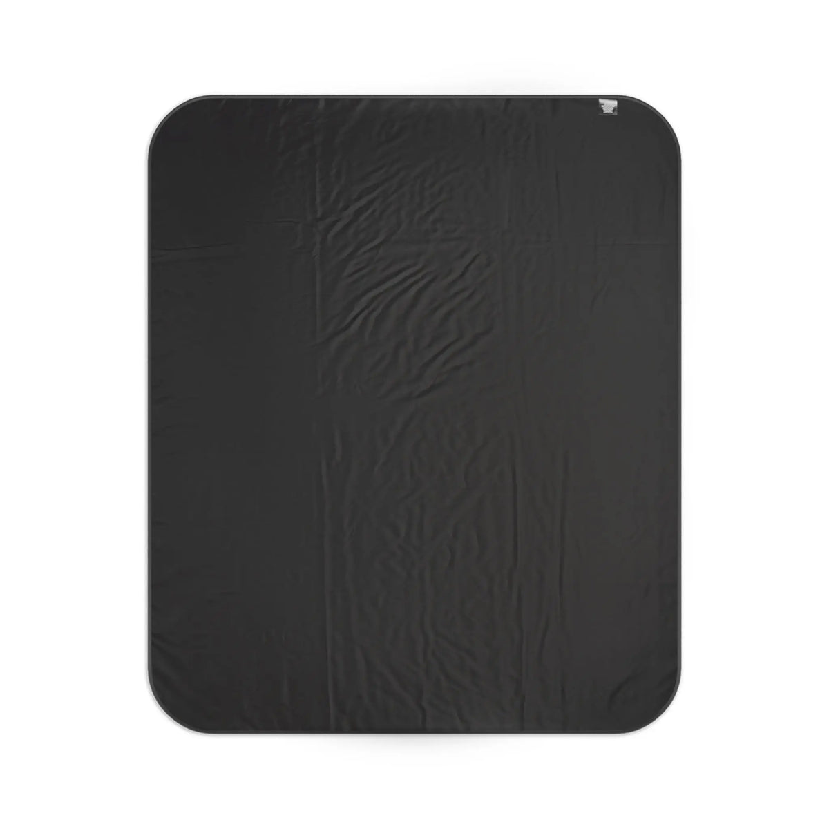 Black textured blanket with rounded corners and a small fabric tag.
